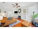 Cozy living room with fireplace, hardwood floors, and view into the dining area at 739 Park Hill Ave, Lakeland, FL 33801