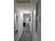 Inviting hallway with contemporary flooring and a view into the rest of the home at 3220 Avenue J Nw, Winter Haven, FL 33881