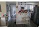 Open kitchen featuring white cabinets, stainless steel appliances, and a breakfast bar area at 3220 Avenue J Nw, Winter Haven, FL 33881
