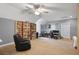 Finished basement with a ceiling fan and large bookcase, perfect for a rec room or entertainment area at 2401 Lafayette Ave, Winter Park, FL 32789