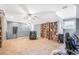 Spacious carpeted basement area with ceiling fan and built-in shelving at 2401 Lafayette Ave, Winter Park, FL 32789