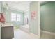 Light and airy bathroom with a soaking tub, marble countertop, and stylish pendant lighting at 2401 Lafayette Ave, Winter Park, FL 32789