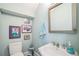 Charming powder room with a white pedestal sink, blue walls, and decorative artwork at 2401 Lafayette Ave, Winter Park, FL 32789