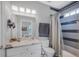 Modern bathroom featuring a shower-tub combination, neutral tones, and a sleek vanity for a clean aesthetic at 2401 Lafayette Ave, Winter Park, FL 32789