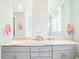 Bright bathroom with double sinks, gray cabinets, and mosaic tile accent wall at 2401 Lafayette Ave, Winter Park, FL 32789