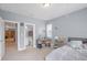 Bright bedroom featuring neutral tones, carpet floors, and an adjacent bathroom for added convenience at 2401 Lafayette Ave, Winter Park, FL 32789