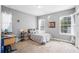 Cozy bedroom with a bed, desk, and ample natural light from two windows at 2401 Lafayette Ave, Winter Park, FL 32789