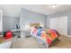Comfortable bedroom with an upholstered headboard, colorful bedding, and neutral walls at 2401 Lafayette Ave, Winter Park, FL 32789