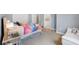Bright bedroom featuring soft carpet, a vanity, and a colorful bedspread in a neutral palette at 2401 Lafayette Ave, Winter Park, FL 32789