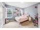 Inviting bedroom featuring neutral walls, a cozy bed, and a practical workspace, blending comfort and utility at 2401 Lafayette Ave, Winter Park, FL 32789