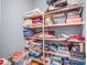 Well-organized closet featuring sturdy wooden shelves loaded with games, clothing, and other household items at 2401 Lafayette Ave, Winter Park, FL 32789