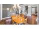 Elegant dining room with a large wooden table, chandelier, and a staircase view at 2401 Lafayette Ave, Winter Park, FL 32789