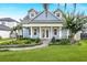 Charming blue two-story home with manicured lawn, lush landscaping, and brick walkway leading to the front door at 2401 Lafayette Ave, Winter Park, FL 32789