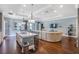 Bright and airy open-concept living space with hardwood floors, modern lighting, and access to the backyard at 2401 Lafayette Ave, Winter Park, FL 32789