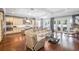 Open-concept living room featuring stainless appliances, spacious island, hardwood floors, and neutral-toned furniture at 2401 Lafayette Ave, Winter Park, FL 32789