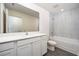 Modern bathroom boasts a large vanity, full mirror, and shower-tub combo with tiled walls at 3228 Seville St, Lake Alfred, FL 33850