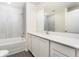 Modern bathroom with white cabinets, tiled walls, and a tub with shower combo at 3228 Seville St, Lake Alfred, FL 33850