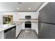 Well-designed kitchen with granite countertops, stainless steel appliances and gray wood flooring at 3228 Seville St, Lake Alfred, FL 33850