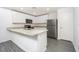 Bright kitchen with granite countertops, stainless steel appliances, and gray wood flooring at 3228 Seville St, Lake Alfred, FL 33850