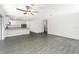 Spacious living room with modern gray wood flooring connected to the open kitchen at 3228 Seville St, Lake Alfred, FL 33850