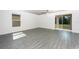 Bright living room featuring sliding door to the back yard and modern gray wood flooring at 3228 Seville St, Lake Alfred, FL 33850