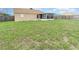 The property features a spacious backyard and view of screened-in patio at 3243 Winchester Estates Cir, Lakeland, FL 33810