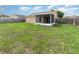 View of the home's exterior and backyard, featuring an enclosed screened in patio at 3243 Winchester Estates Cir, Lakeland, FL 33810