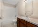 Bright bathroom featuring a bathtub-shower combination and vanity with a framed mirror at 3243 Winchester Estates Cir, Lakeland, FL 33810