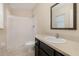 Clean bathroom with tiled shower, dark cabinets, and a sink with a large mirror at 3243 Winchester Estates Cir, Lakeland, FL 33810