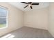 Comfortable bedroom with neutral carpet, fan, and natural light from the window at 3243 Winchester Estates Cir, Lakeland, FL 33810