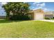 Charming single-story home featuring a manicured lawn, mature landscaping, and a two-car garage at 3243 Winchester Estates Cir, Lakeland, FL 33810