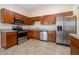 Kitchen with stainless steel appliances, plenty of counter space, and wooden cabinetry at 3243 Winchester Estates Cir, Lakeland, FL 33810