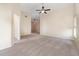 Inviting living room featuring plush carpeting, neutral paint, vaulted ceilings, and a ceiling fan at 3243 Winchester Estates Cir, Lakeland, FL 33810