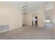 Bright and airy living room showcasing plush carpeting, neutral paint, vaulted ceilings, and modern lighting fixtures at 3243 Winchester Estates Cir, Lakeland, FL 33810