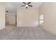Spacious living room featuring plush carpeting, neutral paint, vaulted ceilings, and a ceiling fan at 3243 Winchester Estates Cir, Lakeland, FL 33810