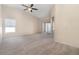 Generously sized main bedroom featuring plush carpeting, vaulted ceilings, a ceiling fan, and access to a screened lanai at 3243 Winchester Estates Cir, Lakeland, FL 33810