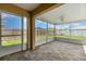 Covered screened-in patio featuring a ceiling fan and exterior view of backyard and fence at 3243 Winchester Estates Cir, Lakeland, FL 33810