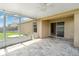 Screened patio with tile flooring and open views to the backyard and home's exterior at 3243 Winchester Estates Cir, Lakeland, FL 33810