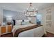 Serene main bedroom featuring a luxurious bed, elegant lighting, and contemporary design elements at 3747 King Hill Dr, Haines City, FL 33844