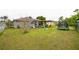 Backyard featuring a covered patio, trampoline, and well-maintained lawn at 107 Talavera Ln, Kissimmee, FL 34758