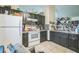 The kitchen offers white appliances, dark cabinets, tile floors, and warm lighting at 107 Talavera Ln, Kissimmee, FL 34758