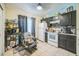 A kitchen with tile floors, white appliances, and dark cabinets is bathed in warm lighting at 107 Talavera Ln, Kissimmee, FL 34758