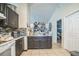 A cozy kitchen with black cabinets, tile floors, and lots of storage at 107 Talavera Ln, Kissimmee, FL 34758