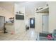 Cozy living room features neutral paint, tile floors, and a view into the kitchen at 107 Talavera Ln, Kissimmee, FL 34758