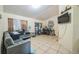 Living room featuring neutral walls, tile flooring, and a gray sofa at 107 Talavera Ln, Kissimmee, FL 34758