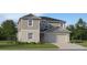 Traditional two-story home with a two-car garage, manicured lawn, and simple landscaping at 1145 Hour Glass Rd, Lakeland, FL 33801