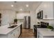 Well-lit kitchen featuring stainless steel appliances and white cabinets at 3763 King Hill Dr, Haines City, FL 33844