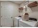 Convenient laundry room with a full-size washer and dryer, shelving, and storage baskets at 3763 King Hill Dr, Haines City, FL 33844