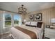 This spacious main bedroom is well-lit by natural light and features stylish modern decor at 3763 King Hill Dr, Haines City, FL 33844