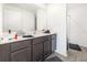 Well-lit bathroom features a large mirror, neutral color scheme, and modern fixtures at 1741 Canaan Loop, Dundee, FL 33838